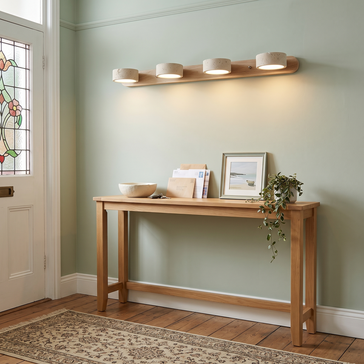 Livia 4-light travertine wall light above a hallway console table
