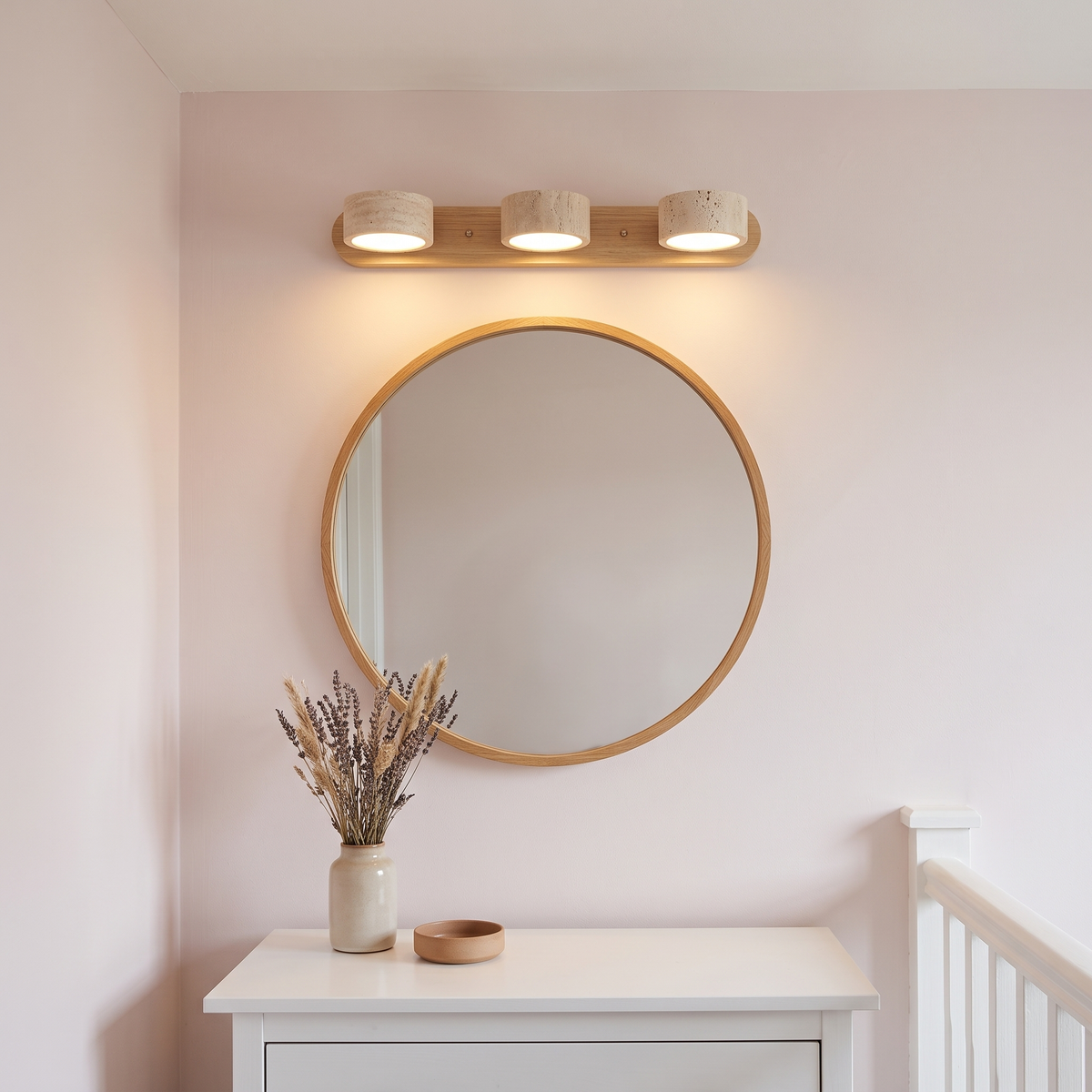 Livia 3-light travertine wall light above a round landing mirror