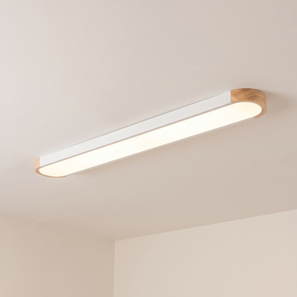 Imogen oval LED ceiling light, white 122 cm, oak wood ends, warm light on a white ceiling