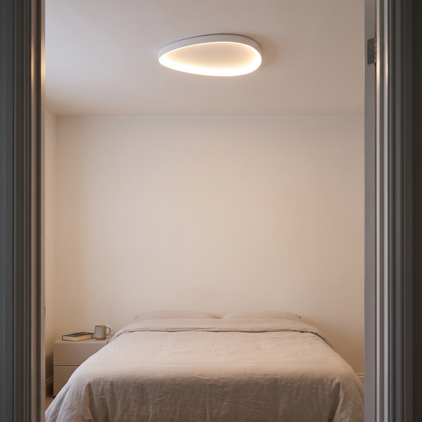 Linara slim LED ceiling light – glowing on a bedroom ceiling