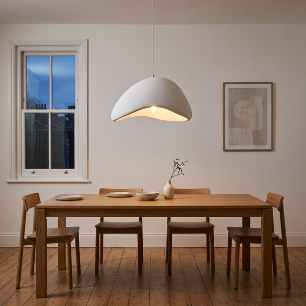 Sabien textured dome pendant – glowing above a dining table