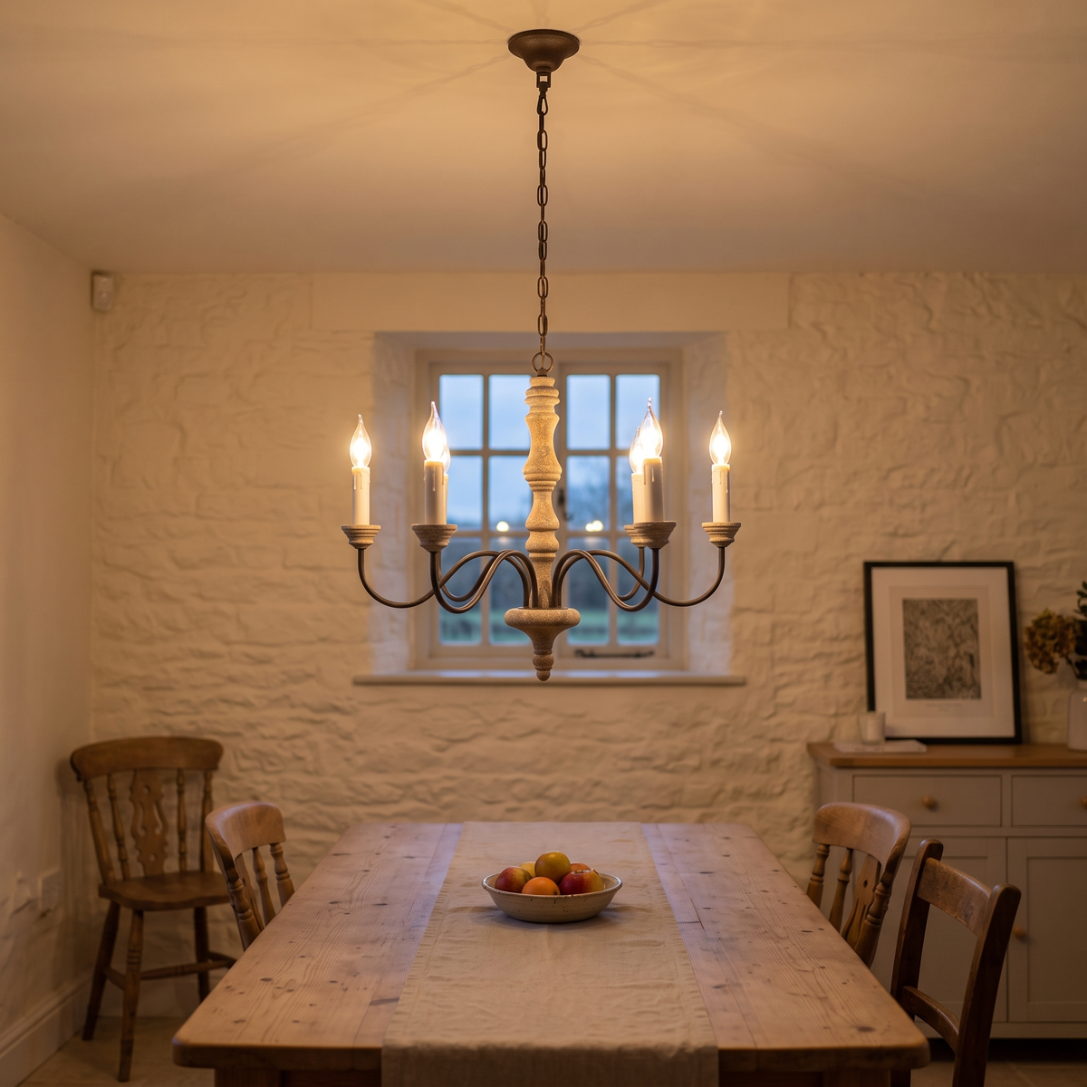 Amalia rustic candle chandelier – glowing above a farmhouse table