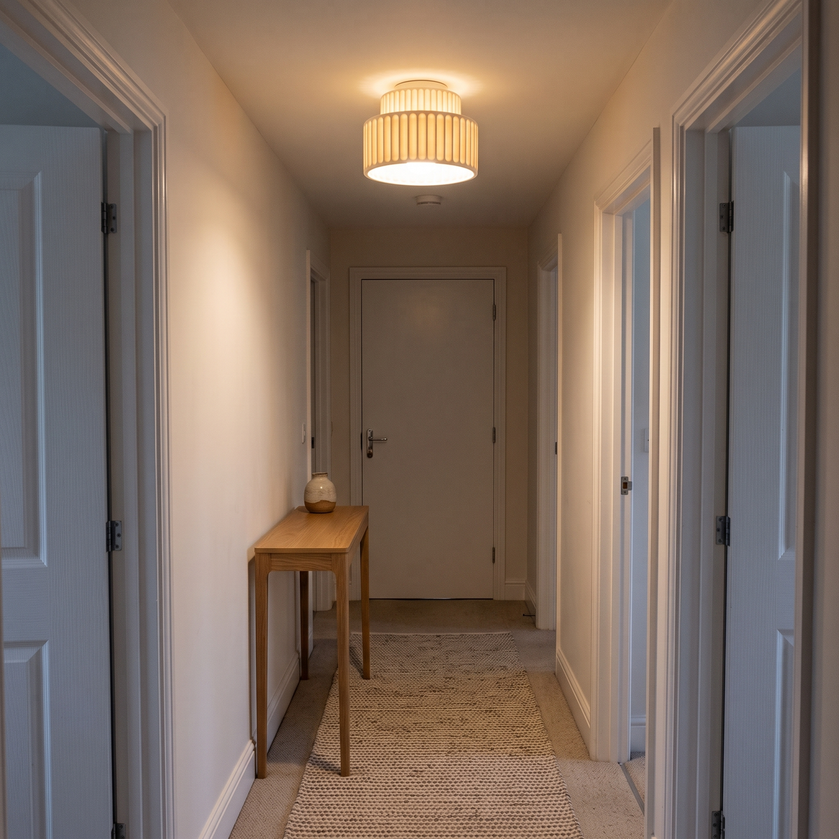 Colette ribbed resin ceiling light – glowing in a hallway