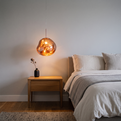 Maribel amber melt pendant – glowing beside a bed