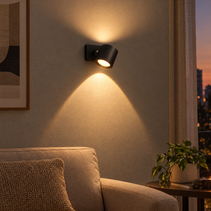 Kenna reading + sunset wall light in black lighting up and down a living room wall