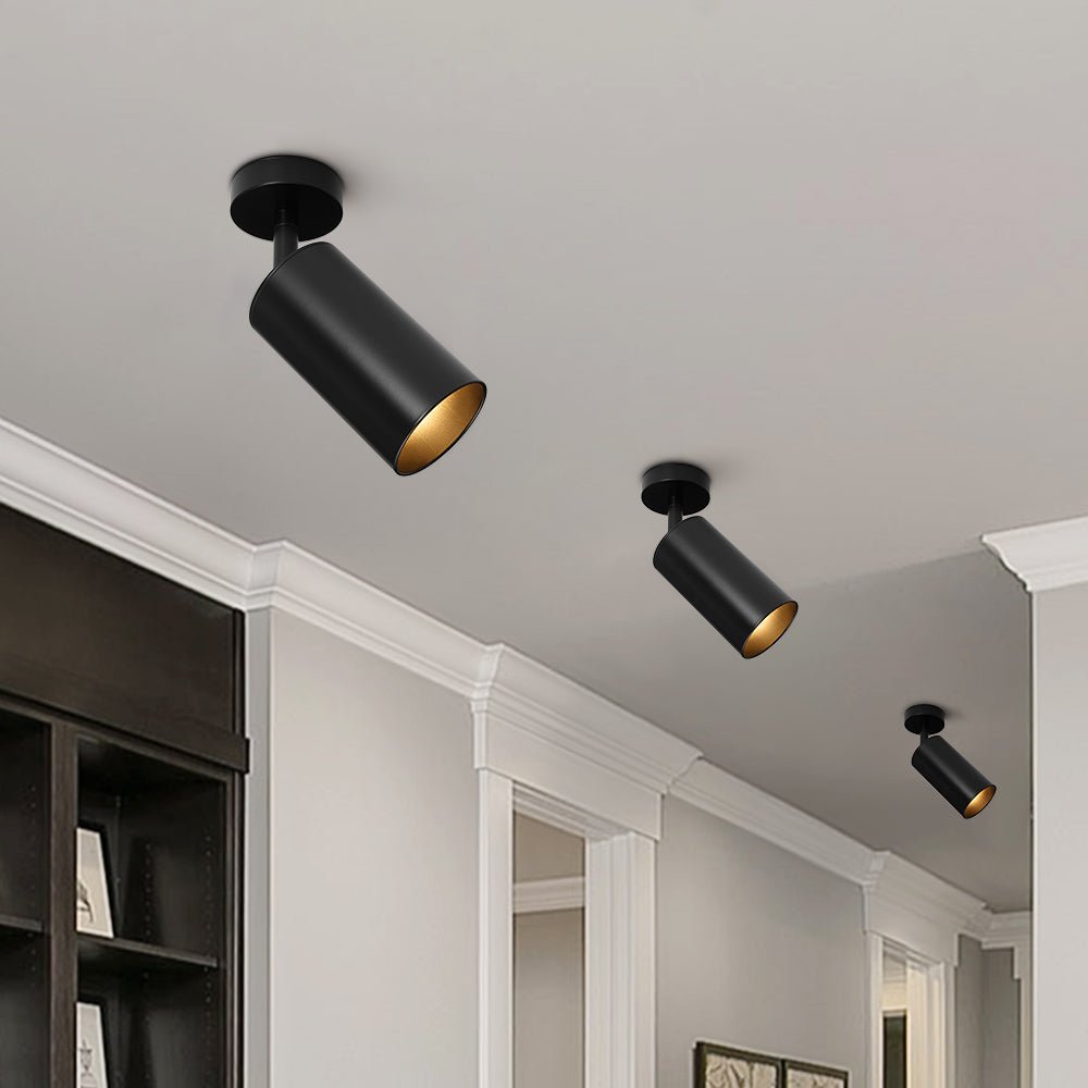 Remy adjustable spot ceiling light – in black in a room