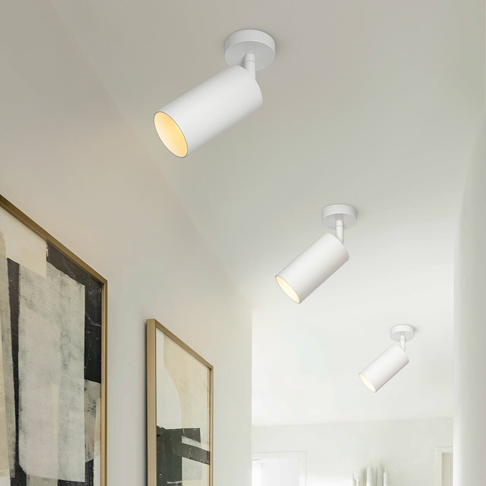 Remy adjustable spot ceiling light – in white in a room