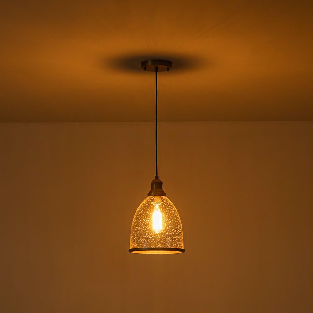 Sienna seeded glass dome pendant – lit in a dark room