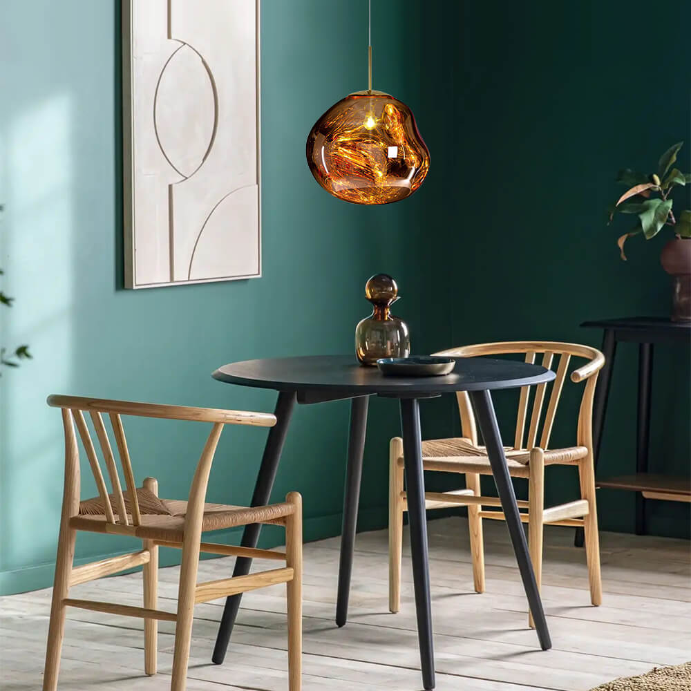 Maribel melt pendant – in gold over a dining table
