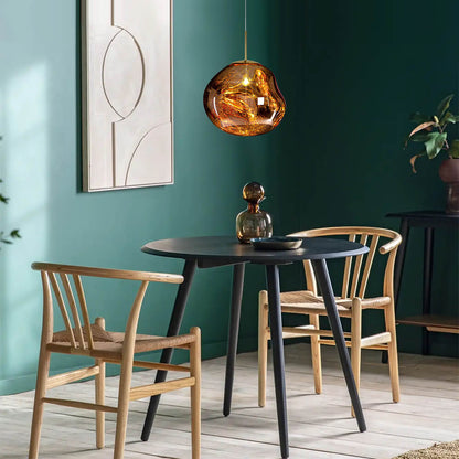 Maribel melt pendant – in gold over a dining table