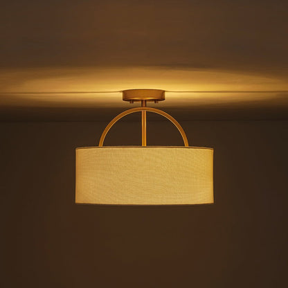 Isadora linen drum ceiling light – lit with a warm glow