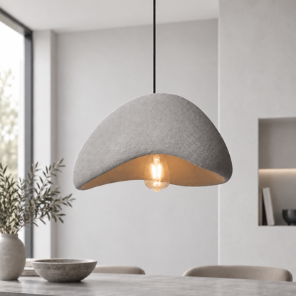 Sabien pendant light with a grey shade hanging in a bright pale interior